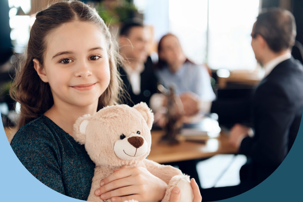 transparency-in-family-courts-header-1024x683 Girl cuddling her teddy smiling at the camera